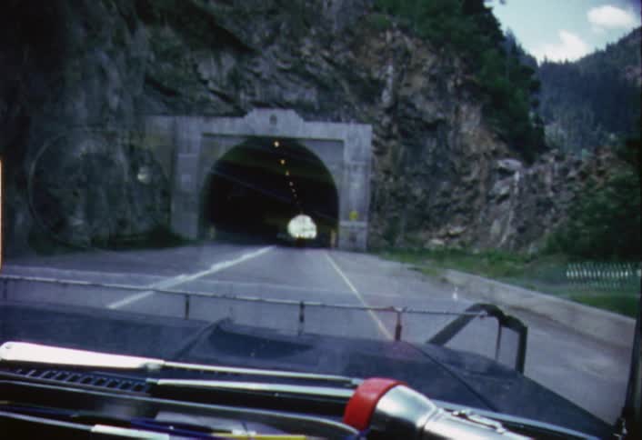 Car driving towards a highway tunnel