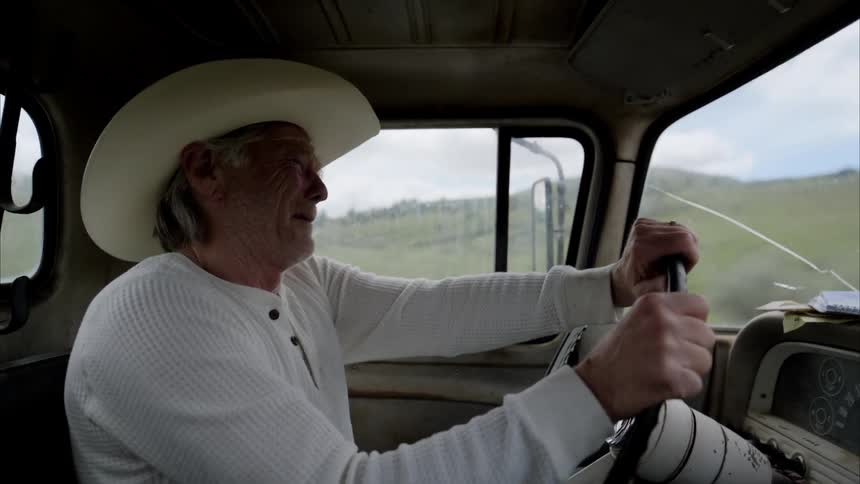 Elderly man driving a vehicle with a facial expression of concern