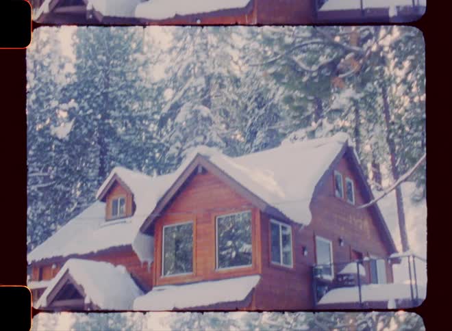 Exterior of a wooden house near a snow covered forest