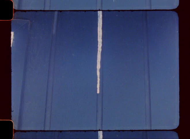 An icicle hangs from the side of a house