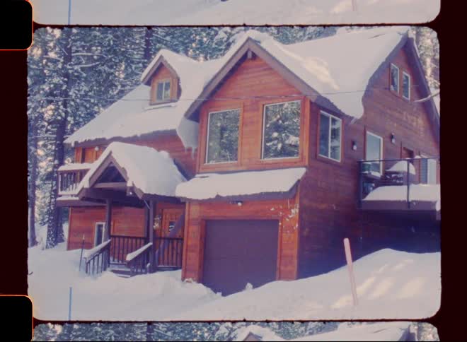 A house covered in snow in a forest