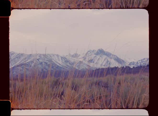 Landscape of a post and mountain ranges covered by snow on a cloudy day