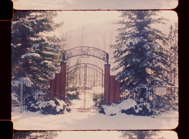 Gate of a property with trees around and snow during winter