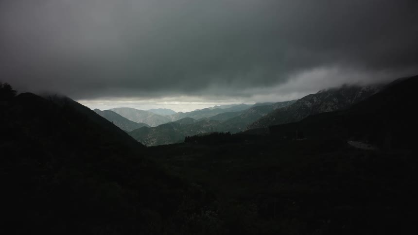 Landscape with mountains on a sunny day with black clouds