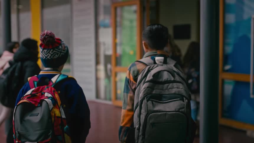 Students make their way to class with backpacks