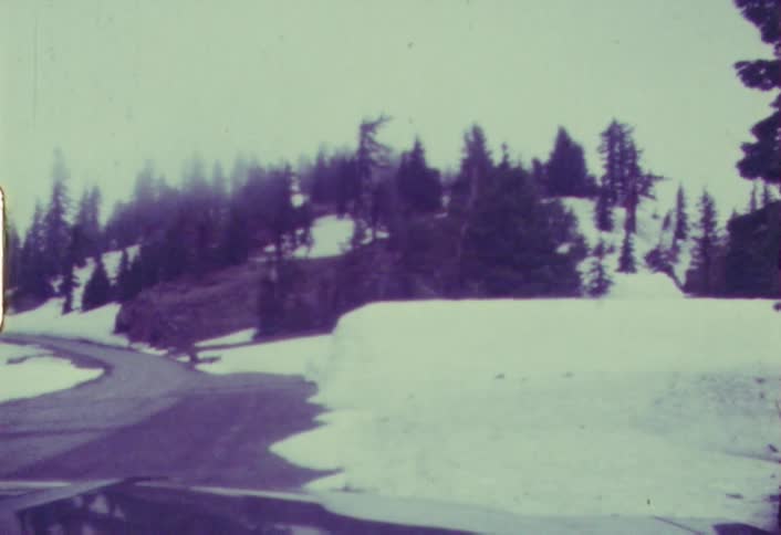 Shaky view of a road  winding through a snowy area