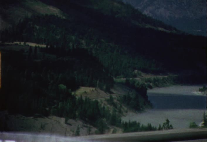 Shaky passing view of a river as seen from a moving vehicle