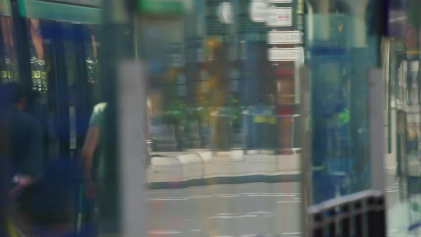 Reflection of pedestrians walking on the sidewalks of the city