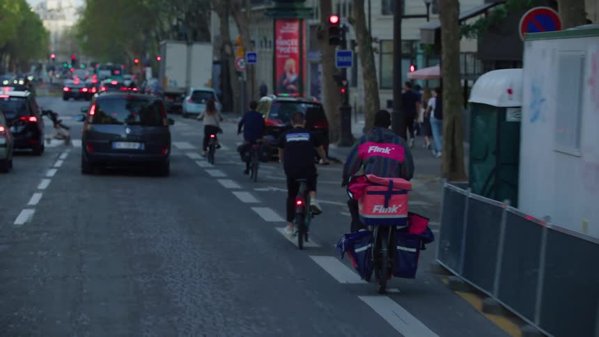 Cars and bicycles on a parisian road