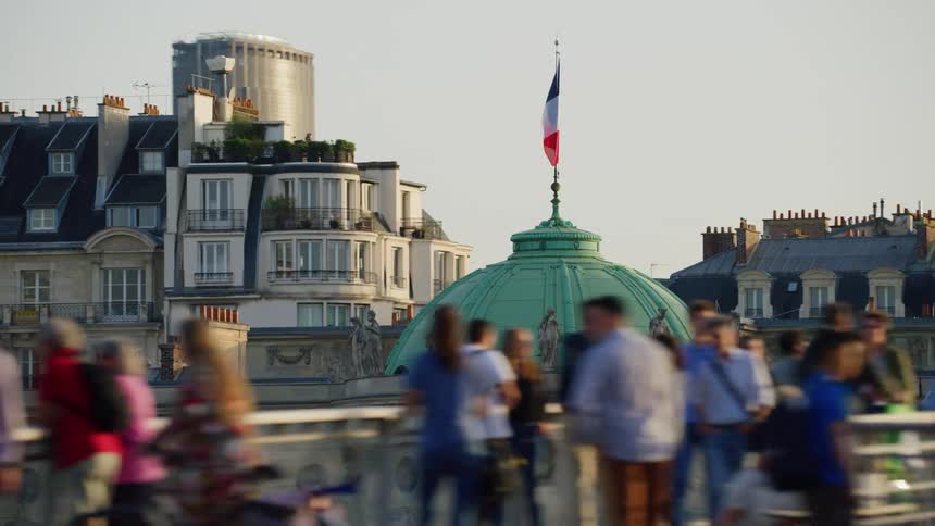 Crowd of people in front of a name with the flag of france in a tourist spot