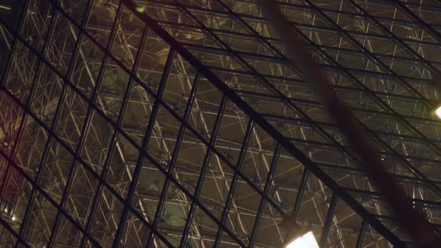Detail of the glass pyramid at the louvre at night