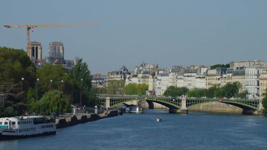 A view of a city with classic architecture along the banks of a calm river