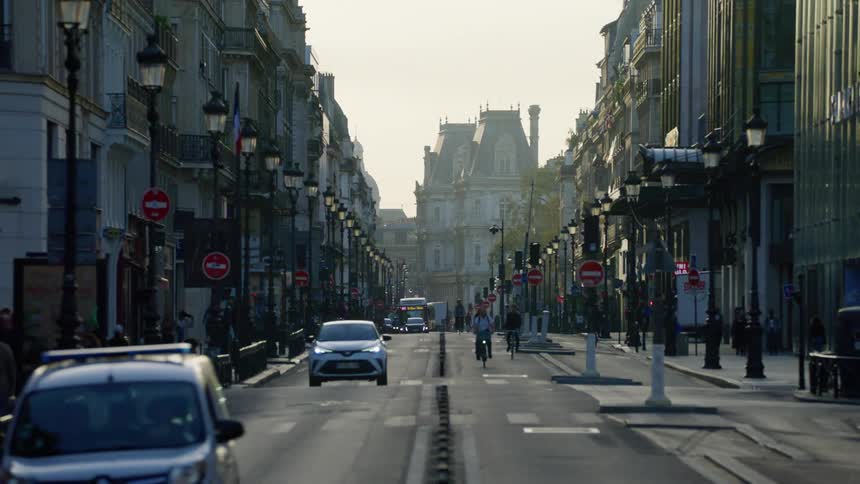Hotel de ville at the end of a street in paris at evening