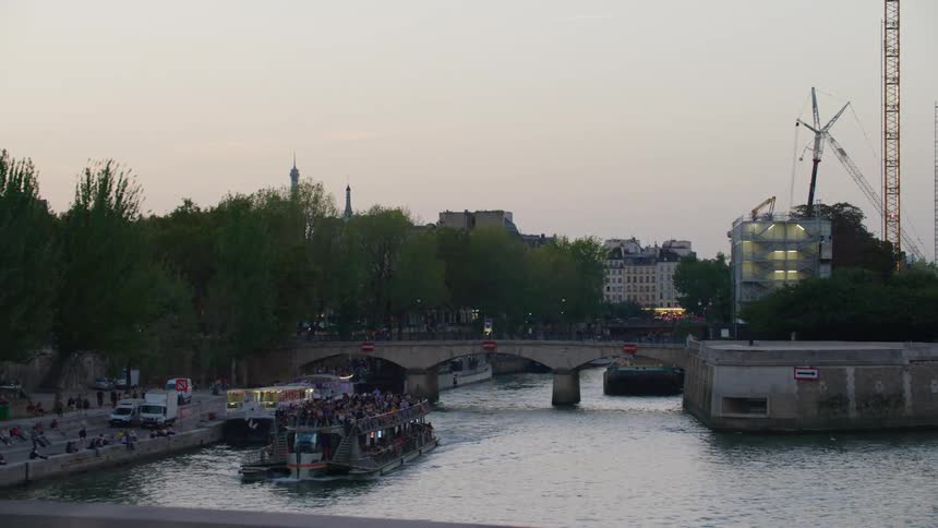A large boat filled with people on a river