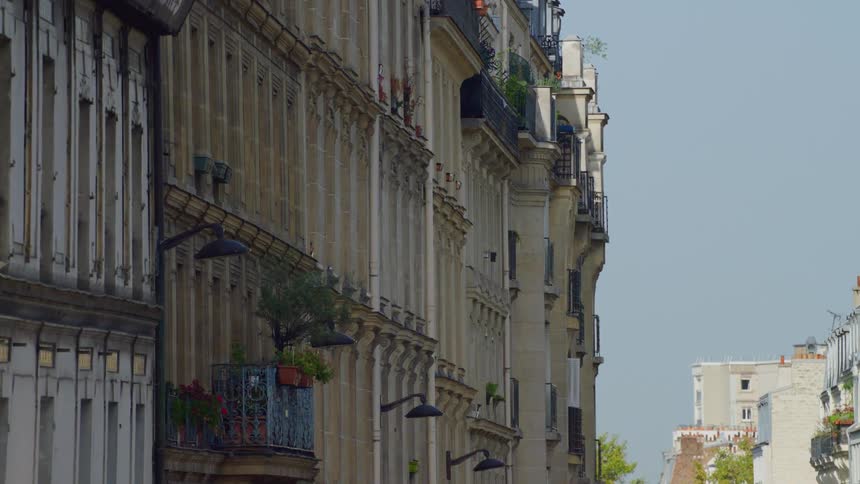 A line of buildings with balconies in a city