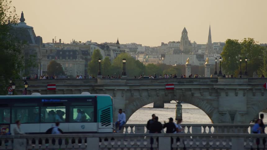 Evening view of a city with historic buildings and a busy bridge