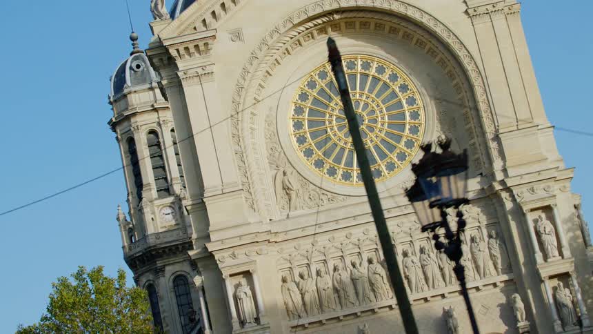 Facade with artistic details of a cathedral on a cloudless blue sky day