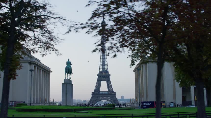 A statue is across from the eiffel tower