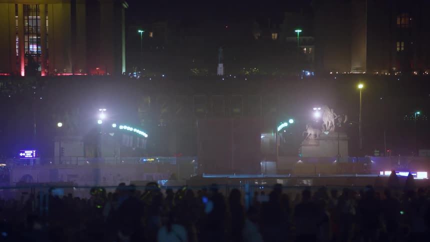 Crowd of people gathered in a square at night in france