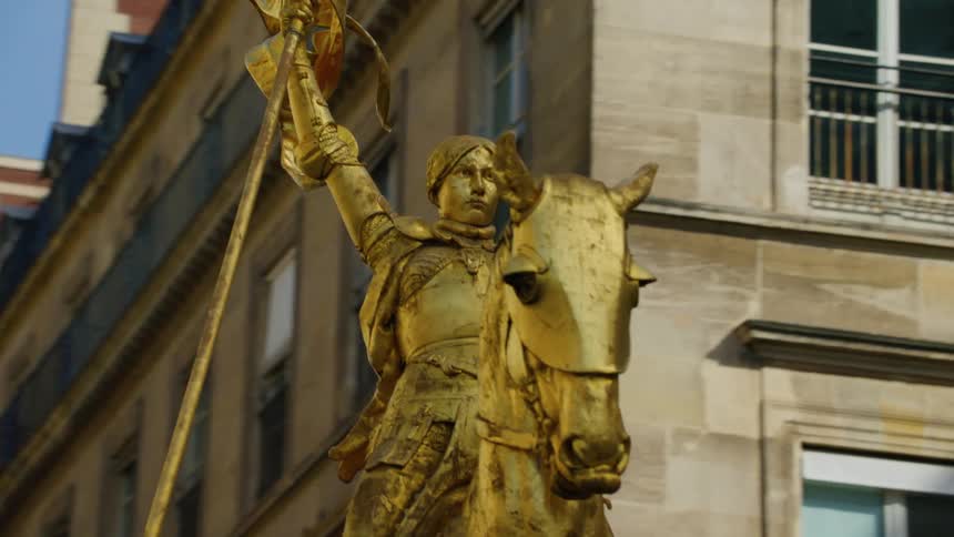 A gold statue is in front of the building