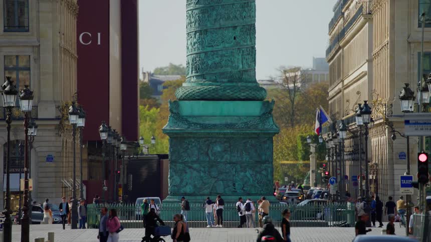 Crowd of pedestrians in the middle of a metropolis with a square with a monument tower