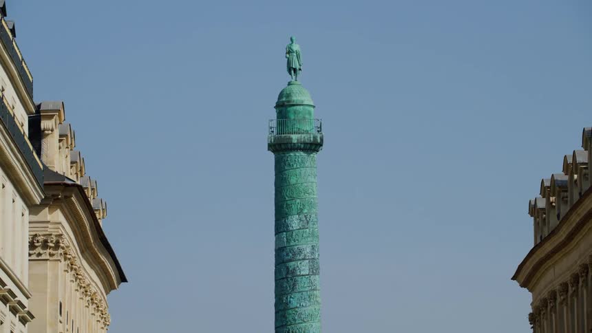 Monuments on a pillar in a square in france in the middle of the city on a blue sky day without light