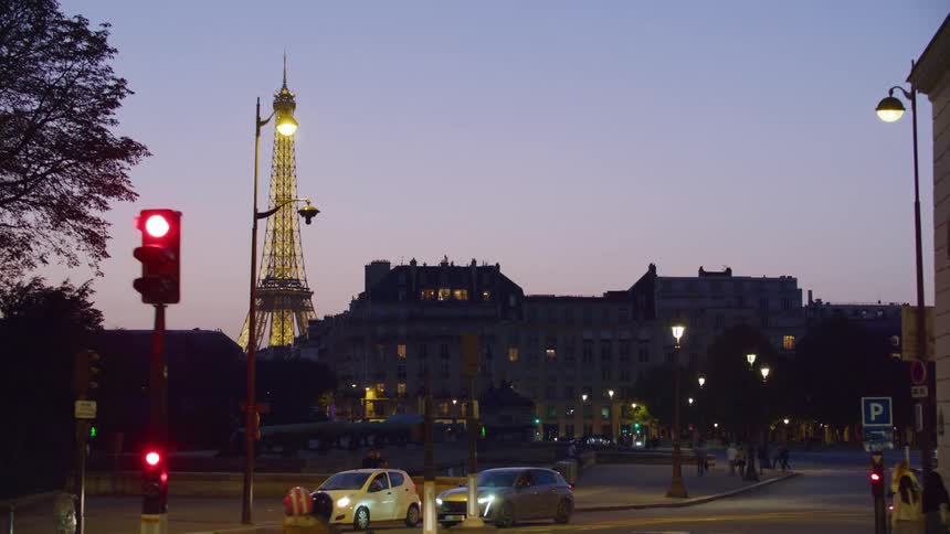 Panorama at night of a street in france with a view of the illuminated eiffel tower