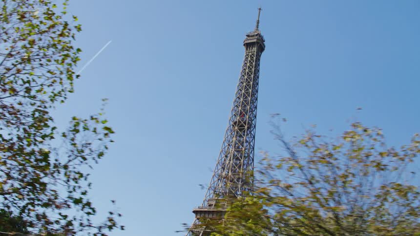 Upward view of the eiffel tower on a cloudless blue sky day