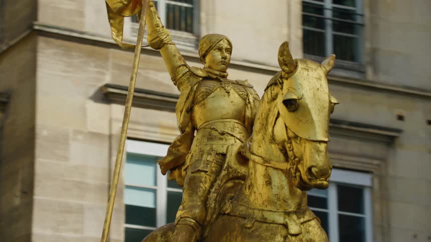 External architecture with closet in a golden monument of a woman holding a flag on top of her horse