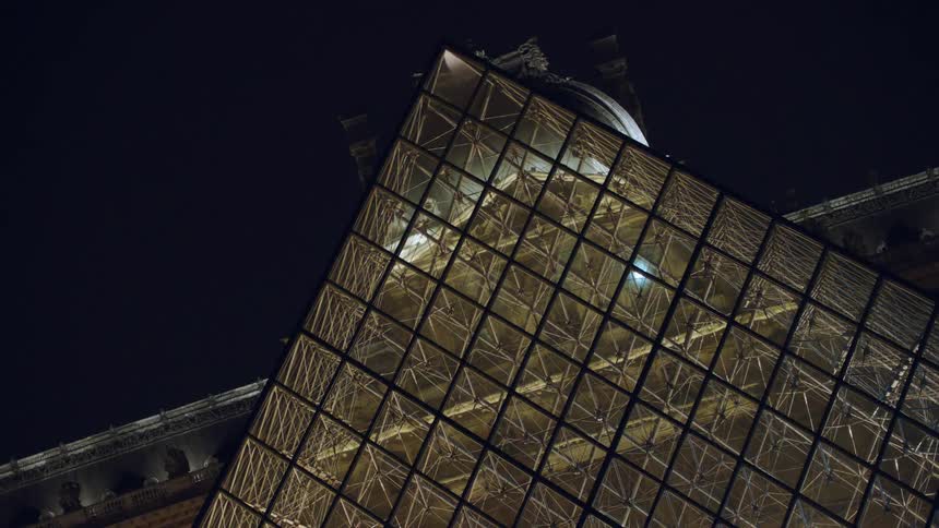 Triangular and mirrored museum in paris france at night