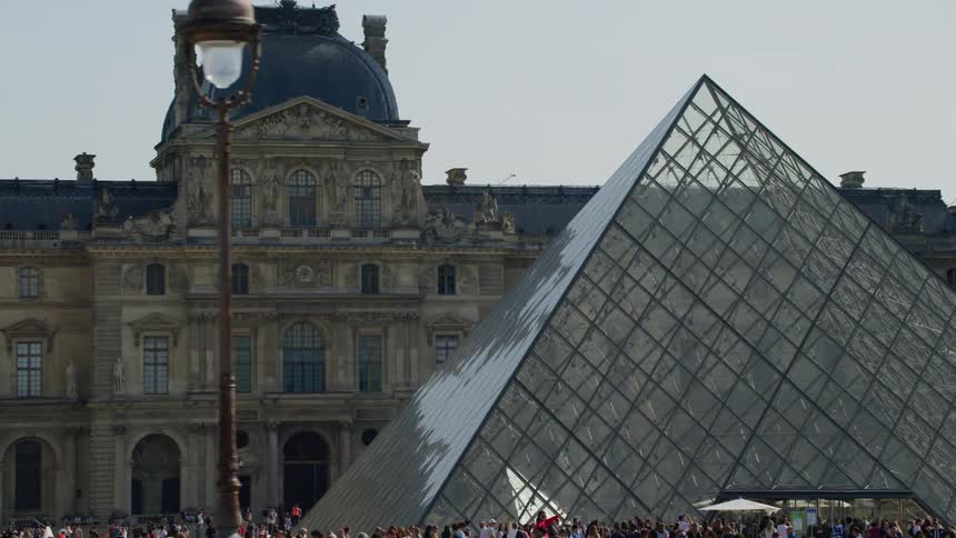 View from outside gave me a crowd of people around the louvre museum in paris france