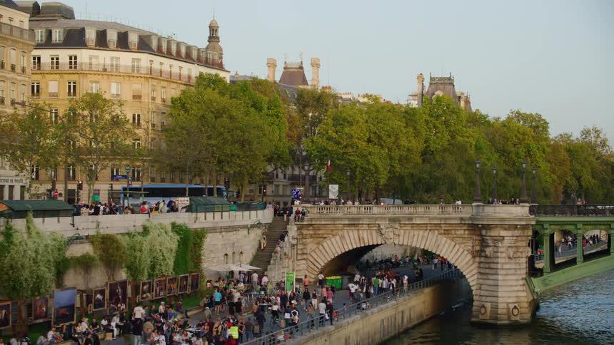 Panorama of bridges over a lake in a city with vehicle traffic and a crowd of people