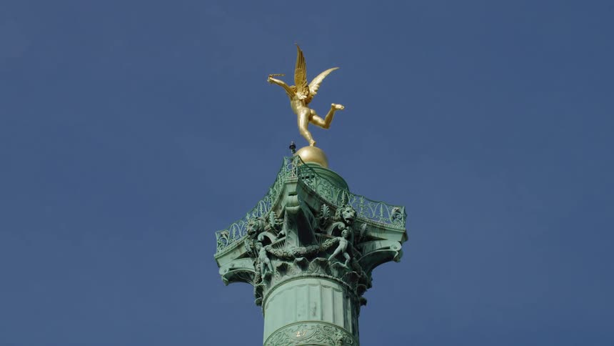 A clip of a golden statue on a tower