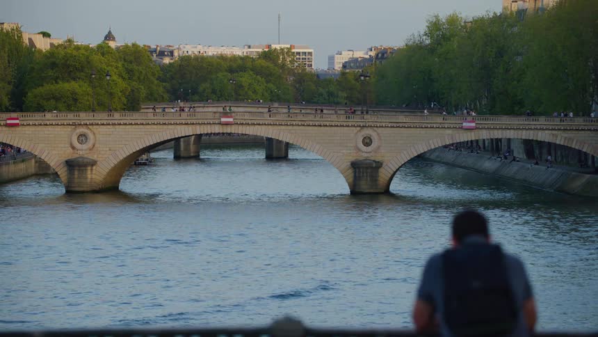 Bridges over a lake on a canal connecting cities with people passing by