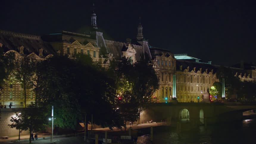 Exterior architecture of a gothic and famous building in a city at night by the sea
