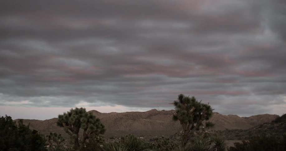 Clouds pass above a desert landscape