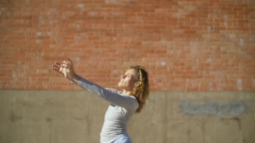 A woman dancing in an urban area