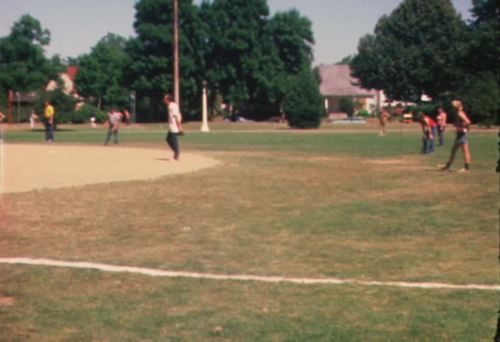 Group of people gathered on a baseball field