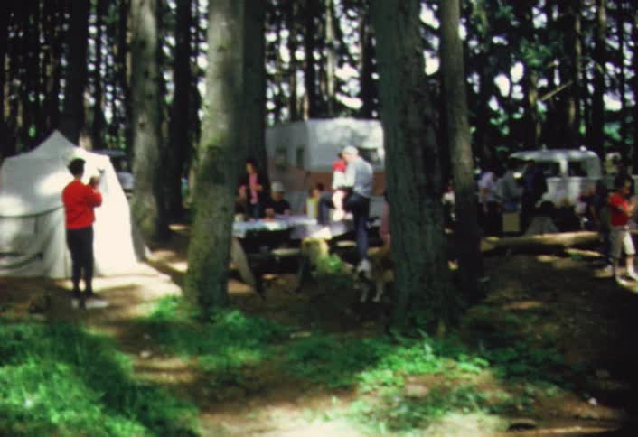 Gathering of people at a campsite with tents and rvs