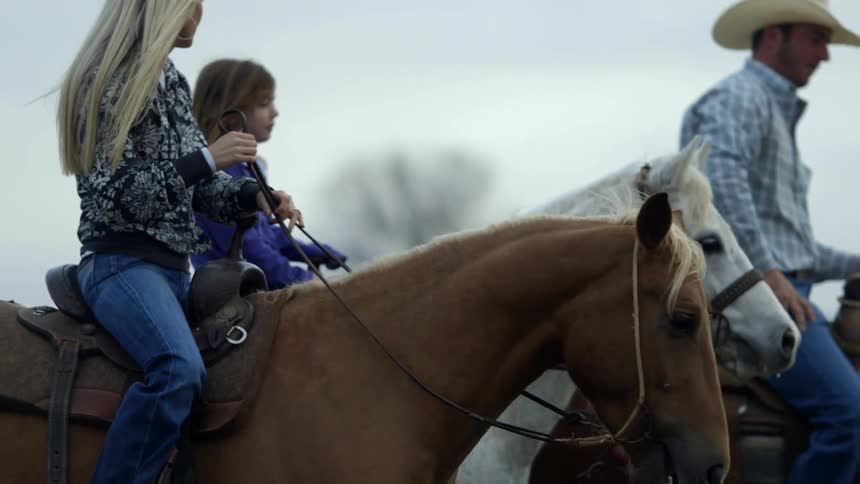 Parents and a child riding horses together