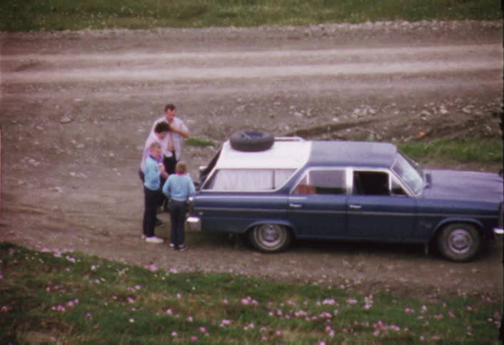 Family standing outside of a car