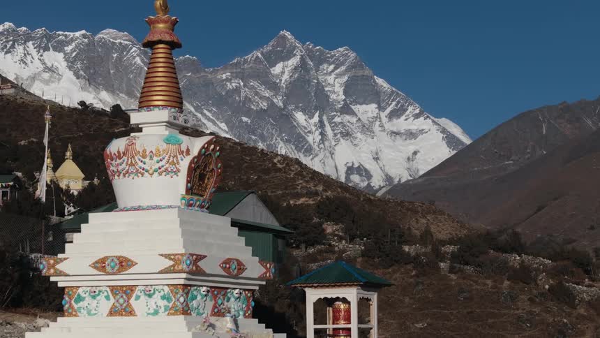 Temple amid mountains in winter on a blue sky day