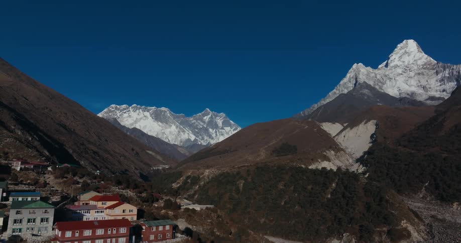 Aerial of a village in the mountains on a sunny day