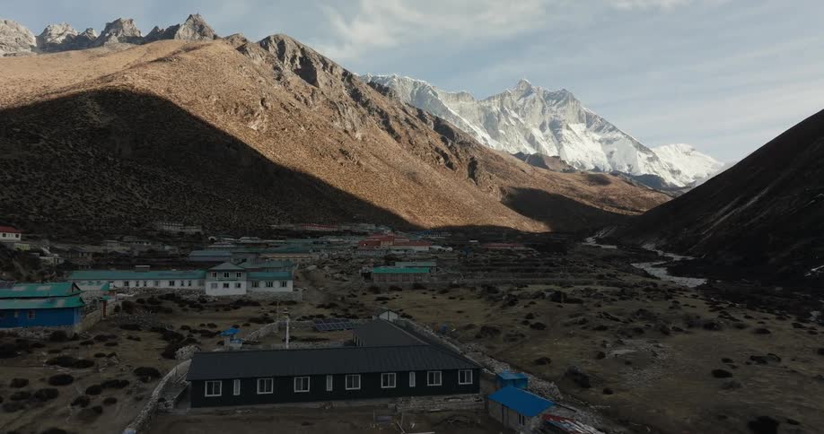An aerial view of a rural community outdoors in the mountains