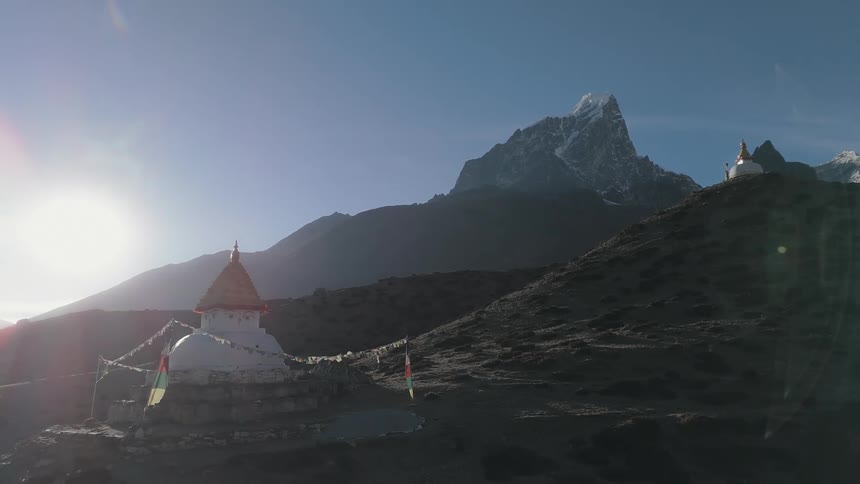 Sanctuary in the middle of mountains with a sun reflecting on the horizon