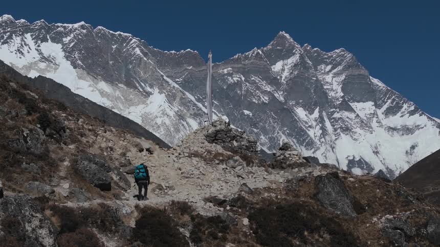 A man hiking up in a mountain area