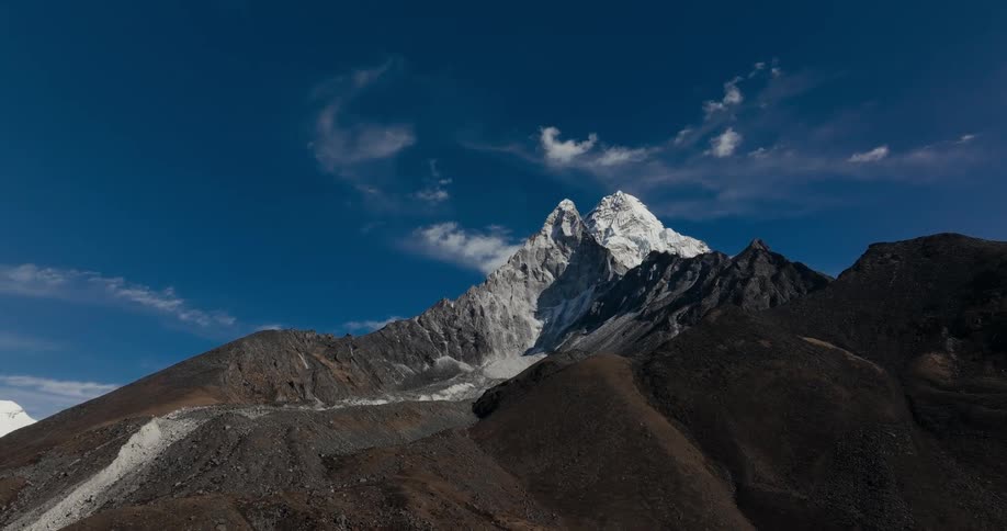 View of a rocky ground formed by plateaus and snowy mountain peak