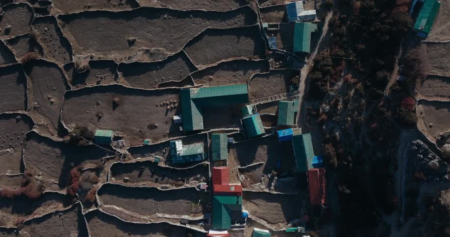 Aerial view of houses in a village on a plateau in the mountains