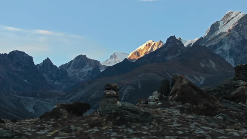 Man hiking under the mountains in winter during the day