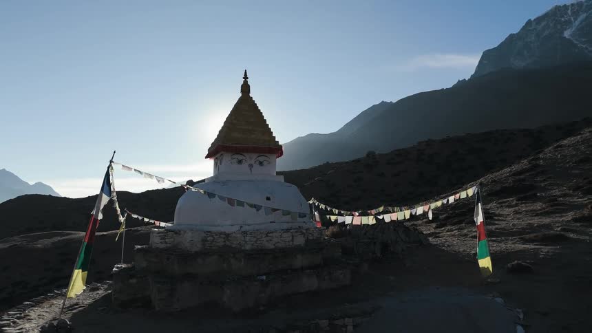 Religious sanctuary on a rocky mountain on a blue sky day with solar flare